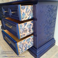 a blue dresser with drawers painted in different colors and patterns on the front, side, and top