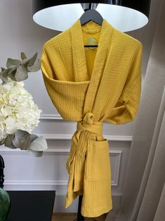 "This soft stylish bathrobe made of 100 % cotton muslin fabric can be used for various places and occasions and it is available in different colors and sizes. This robe has two pockets and belt and also robe can be with hood or no hood. The length of the robe is below the above the knee. It has elegant wide sleeves. The sleeves are 3/4 long. Please use your largest measurements as a reference for choosing the best size. ::SIZING INFORMATION:: S/M: Bust: 33-37\" Waist: 26-28\" Hip: 37\" Sleeve le Long Cotton Loungewear Robe, Long Sleeve Cotton Robe For Hospital, Cotton Wrap Robe For Home, Cotton Wrap Robe For Daywear, Long Cotton Sleep Robe, Long Cotton Home Robe, Muslin Clothing, Hooded Gown, Linen Napkins Wedding