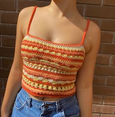 a close up of a person wearing a top with crocheted designs on it