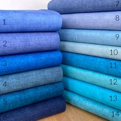 the blue sheets are stacked on top of each other in different sizes and colors, along with numbers