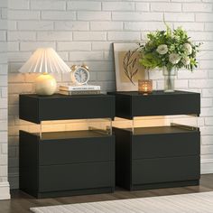 two black nightstands with gold trim on each side and white brick wall in the background