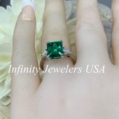 "May Birthstone Ring, Emerald Cut Engagement Ring, Moissanite Engagement Ring, Three Stone Ring, Large Cocktail Ring, 14k White Gold Ring #6722 Emerald is the birthstone of May -Approximate total carat weight: ctw diamond equivalent -Center Stone Size: 10x8mm approx. 3.55ct diamond equivalent -Center Stone Shape: emerald cut -Gem Type: lab created emerald -Stone Clarity: VS2 -Stone Color: lively medium green, eye-clean -Moh's Scale: 8.5 hardness -Accent Stones: 2 pear shapes -Accent Stones Size: Formal Radiant Cut Ring With May Birthstone, Formal Radiant Cut May Birthstone Ring, Diamond Ring With Prong Setting For May Birthstone, Gift Emerald Moissanite Ring With Asscher Cut, May Birthstone Diamond Ring With Asscher Cut, Radiant Cut Diamond Ring For May Birthstone, Radiant Cut Rings With Center Stone For May Birthstone, Fine Jewelry Emerald Promise Ring With Center Stone, Fine Jewelry Emerald Ring With Center Stone For Promise