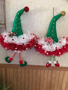 two christmas wreaths are hanging on the wall