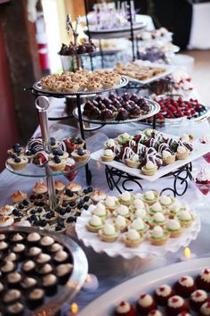 a table topped with lots of different types of desserts