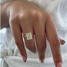 a woman's hand with a diamond ring on it