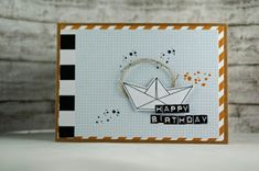 a close up of a card with a paper boat on it and the words happy birthday