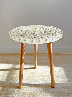 a white table sitting on top of a carpet covered floor