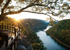 the sun shines brightly over a scenic river