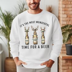 Embrace the festive spirit with our "It's the Most Wonderful Time For a Beer, Reinbeer Sweatshirt" this holiday season. Perfect for beer enthusiasts and lovers of all things Christmas, this sweatshirt effortlessly combines humor and style. Whether you're looking for a unique Christmas sweater or a fun gift for a beer-loving friend, this sweatshirt is sure to bring cheer. The clever design celebrates the joy of the season with a playful twist, making it a standout piece during holiday gatherings. Beer Season, Funny Beer Shirts, Beer Theme, Funny Beer, Gifts For Beer Lovers, Beer Humor, Holiday Wardrobe, Wonderful Time Of The Year, Beer Shirts