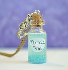 a bottle necklace with a mermaid tears message on it