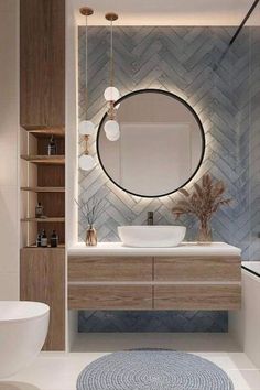 a bathroom with a round mirror above the sink and a blue rug on the floor