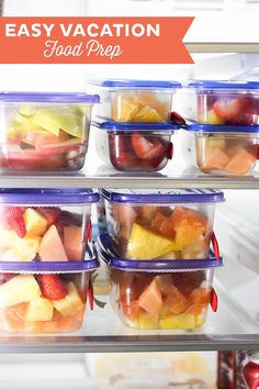 several plastic containers filled with fruit sitting on top of an open refrigerator