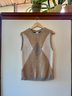 Gorgeous vintage 80s hand knit textured sleeveless sweater.  Made of 55% ramie and 45% acrylic. Love the neutral color combo. By BRAMBLE LANE. Size M. WE In good vintage condition. Showing light signs of normal age and wear.  Measurements taken while item was laying flat.  Bust: 18.5" Length: 24.5" Beige Textured Knit Sweater Vest For Layering, Beige Textured Knit Sweater Vest, Vintage Knitted Sweater For Layering, Retro Beige Knit Tops, Beige Knit Retro Top, Fitted Beige Cable Knit Sweater Vest, Fitted Textured Knit Sweater Vest, Sleeveless Textured Knit Cotton Sweater, Vintage Sleeveless Sweater For Winter