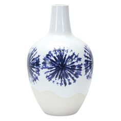 a blue and white vase sitting on top of a table