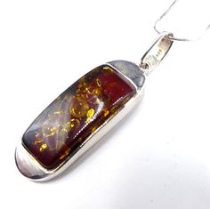 "Vintage marked 925 sterling silver and amber pendant necklace, In good vintage condition, It's 24\" long. Pendant 2\" ¼ long 5/8\" wide. Weighs 13.3 gram. Thanks." Silver Baltic Amber Pendant Necklace, Silver Baltic Amber Necklace With Polished Finish, Formal Amber Necklace With Large Pendant, Amber Necklace With Large Pendant For Formal Occasions, Amber Large Pendant Necklace For Formal Occasions, Amber Pendant Jewelry Stamped 925, Amber Sterling Silver Necklace With Polished Finish, Sterling Silver Necklace With Large Amber Pendant, Formal Baltic Amber Pendant Jewelry