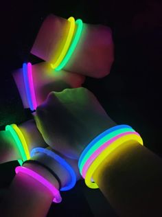 glow bracelets are glowing in the dark with neon colors on their wristbands