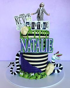 there is a cake that has the name natalie on it and clowns around it