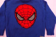 a blue sweater with a spiderman face on it