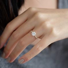 a woman's hand with a diamond ring on it