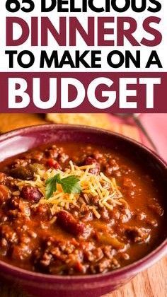 a bowl filled with chili and cheese on top of a wooden table