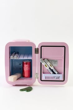 a pink lunchbox with compartments filled with pens and pencils