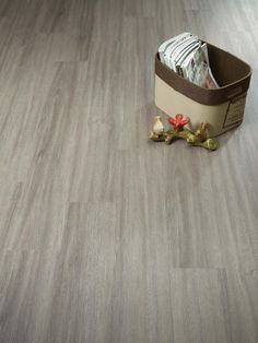 an open suitcase sitting on top of a wooden floor next to a pile of papers