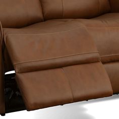 a brown leather reclining couch sitting on top of a white floor