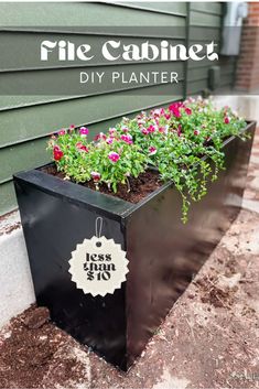 a black planter with pink flowers in it and the words free cabinet diy planter