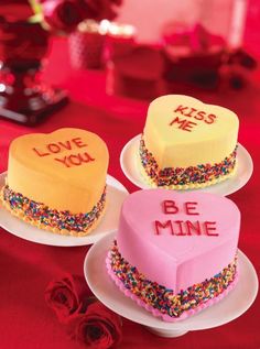 three heart shaped cakes with the words love you and be mine written on them