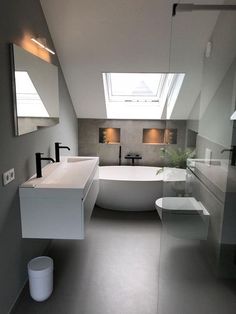 a bathroom with a large tub and sink in it's center, next to a toilet