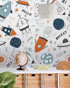 the wallpaper in this room is very colorful and has space related objects on it