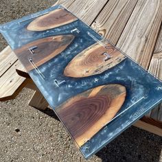 three pieces of wood sitting on top of a wooden table next to a picnic table