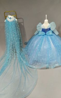 two blue dresses are sitting next to each other