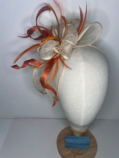 Orange & cream high-quality sinamay bow attached to coordinating headbands for easy wear. Each fascinator is crafted by hand, ensuring that no two pieces are exactly alike. Our bow design fascinators are available in a variety of colors to match any outfit. Whether you're looking for a bold pop of color or a subtle neutral tone. 🖤This head piece looks simply stunning and is perfect for weddings, special occasions or a day at the races.  🖤All head pieces are finished with matching headband wrapped in co-ordinating silk ribbon or secure millinery elastic which is comfortable and easy hidden. 🖤Shipped in a sturdy (keepsake) box and packed with special love and care.  🖤Made in the UK - customised fascinator orders are welcome. Please send me a message and we can create something unique.  T White Adjustable Bow For Wedding, Adjustable White Bow For Wedding, Adjustable Satin Bow Hair Accessories For Wedding, Elegant Orange Fascinator For Wedding, Adjustable Wedding Hair Accessories With Decorative Bow, Cream Satin Bow For Wedding, Cream Ribbon Wedding Bow, Adjustable Wedding Hair Accessories With Satin Bow, Adjustable Bow Hair Accessories For Wedding