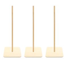 three wooden sticks are standing on top of each other in front of a white background