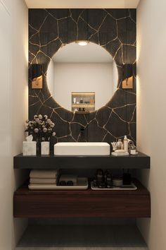 a bathroom with a sink, mirror and lights on the wall above it's counter