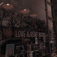 there is a store front window that has books on display in the window and it says love & read books