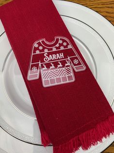 a white plate topped with a red scarf