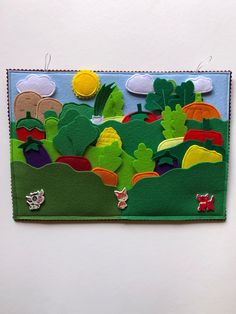 an art piece made out of felt with animals and trees