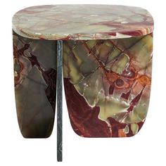 an artistically designed side table with red and green marbled design on the top