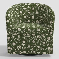 a green chair with white flowers and leaves on the back, in front of a gray background