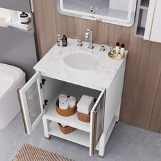 a bathroom with a sink, mirror and toiletries on the counter in front of it