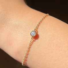 14k Solid Gold Dainty Chain Bracelet, Real Gold Bezel Bracelet, Premium Moissanite Bracelet For Her with premium grade D Color (colorless) VS/SI clarity moissanite.  Our chain is a special diamond cut chain with 1.35 mm thickness. It's dainty and sturdy. The moissanite is 0.25 ct. We're offering the finest quality in solid gold jewelry.  💙 Our jewelry is handcrafted with love and great care at San Francisco Bay! All of our items are 14k stamped for authenticity. 💙 You will receive them exactly as pictured. We don't use any filters, all photos are authentic and unedited. 💙 The material is 14k solid gold and should not be confused with gold plating or filling. It won't tarnish or fade over time. 💙 Quick shipping - Your order will be handcrafted and shipped in a few days. 💙 For the highe