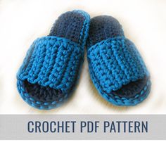 a pair of crochet slippers sitting on top of a bed