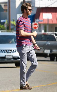 a young man is playing frisbee in the parking lot