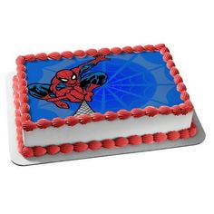 a spiderman cake with red icing on it