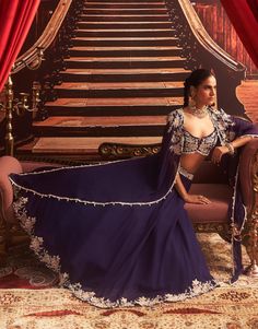 Dazzle in this purple embellished blouse, paired with a flowing cape and a lehenga featuring cancan for dramatic volume. The intricate embellishments add a touch of glamour, making this ensemble perfect for grand celebrations and special occasions where you want to shine. Embroidered Cape, Glamorous Outfits, Vacuum Storage, Embroidered Lehenga, Ready To Wear Saree, Indian Wedding Wear, Lehenga Blouse, Embellished Blouse, Sleeves Blouse