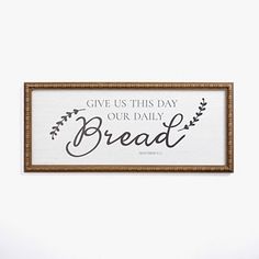 a sign that says give us this day our daily bread on the wall above it