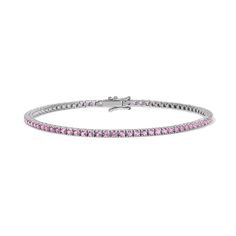 Enhance your jewelry collection with the captivating beauty of our Pink Sapphire Tennis Bracelet. Adorned with vivid pink gemstones, this exquisite piece radiates elegance and charm. Available in 14K Yellow Gold and White Gold Carat weights are reflective of a 7in bracelet. Shorter lengths will have lower carat weights that those listed. Gemstones are natural, therefore colors may vary Classic Pink Tennis Bracelet With Jubilee Style, Classic Pink Tennis Bracelet With Jubilee Design, Pink Jubilee Tennis Bracelet In Classic Style, Classic Pink Tennis Bracelet, Pink Bracelets With Sparkling Stones, Fine Jewelry Bracelets With Sparkling Stones, Pink Bangle Tennis Bracelet As Gift, Formal Pink Gemstone Tennis Bracelet, Luxury Pink Jewelry With Prong Setting