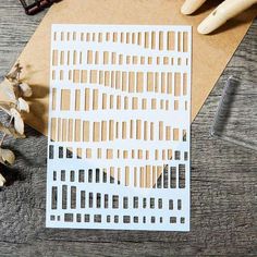 a piece of paper cut out to look like a cityscape on top of a wooden table